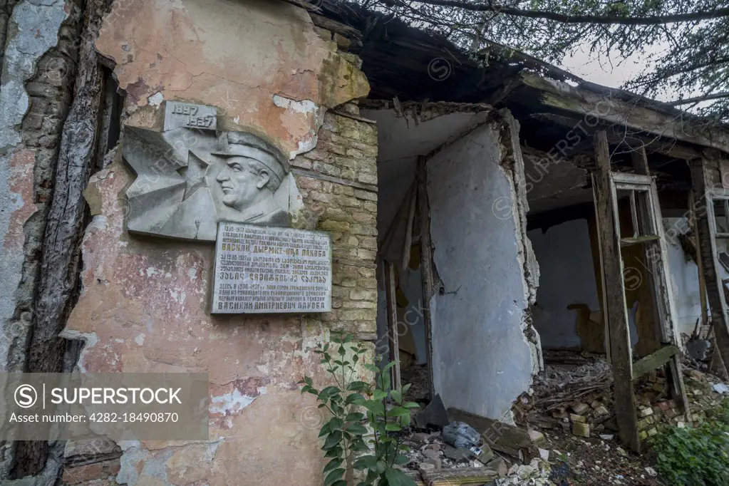 A plaque commemorates the now destroyed former residence of a hero of the Russian Civil War in Abkhazia.