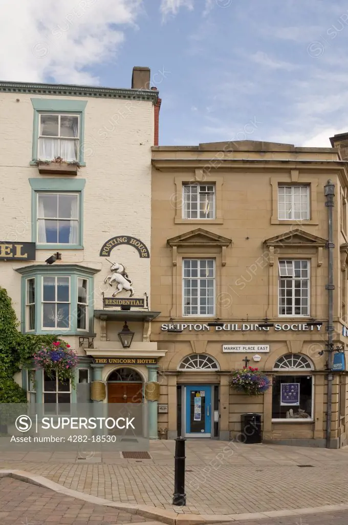England, North Yorkshire, Ripon. The Unicorn Hotel and Skipton Building Society in Market Place East.