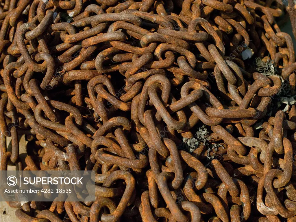 England, North Yorkshire, Whitby. Close up of rusty anchor chains on the quayside.