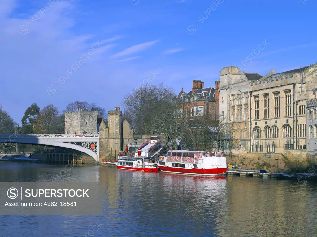 England, North Yorkshire, York. Pleasure boats on the River Ouse by York Guildhall and Lendal Bridge.