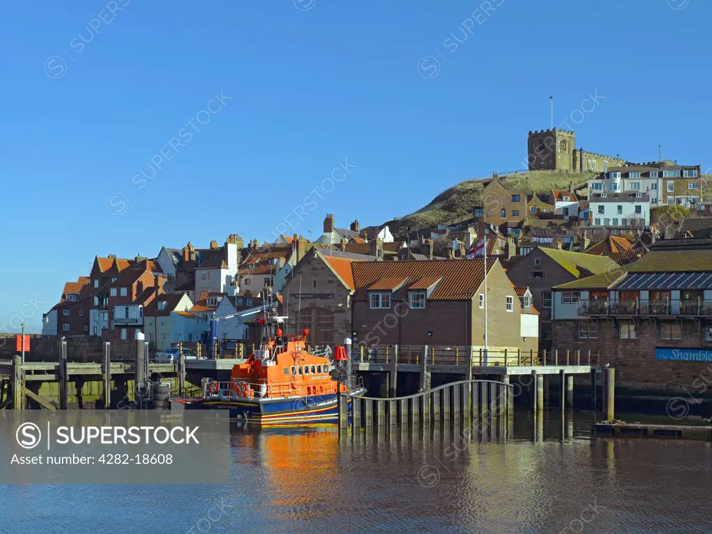 England, North Yorkshire, Whitby. St Mary's Church on East Cliff overlooking the George and Mary Webb all weather lifeboat outside Whitby Lifeboat Station.