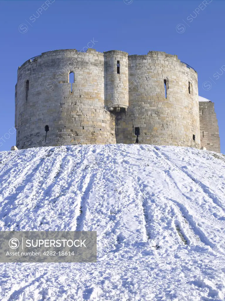 England, North Yorkshire, York. Clifford's Tower, a stone keep built in the 13th century, on top of a motte covered in snow.