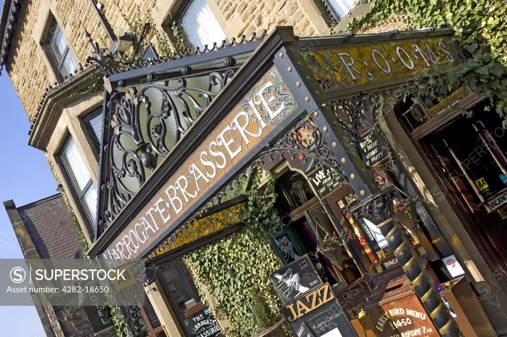 England, North Yorkshire, Harrogate. Ornate glass sign and entrance to the Harrogate brasserie boutique hotel.