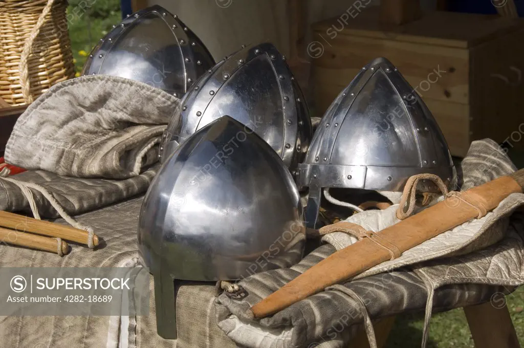 England, North Yorkshire, Helmsley. Medieval helmets and sheaths on a table.