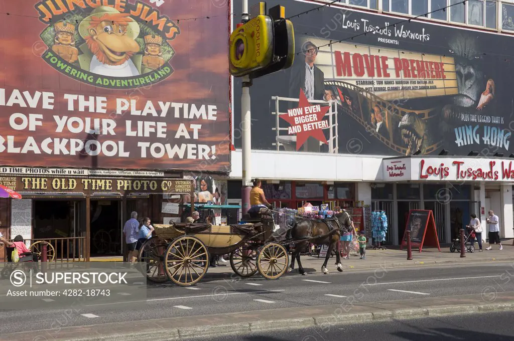 England, Lancashire, Blackpool. Horse and carriage outside Louis Tussaud's Waxworks on the Golden Mile in Blackpool.