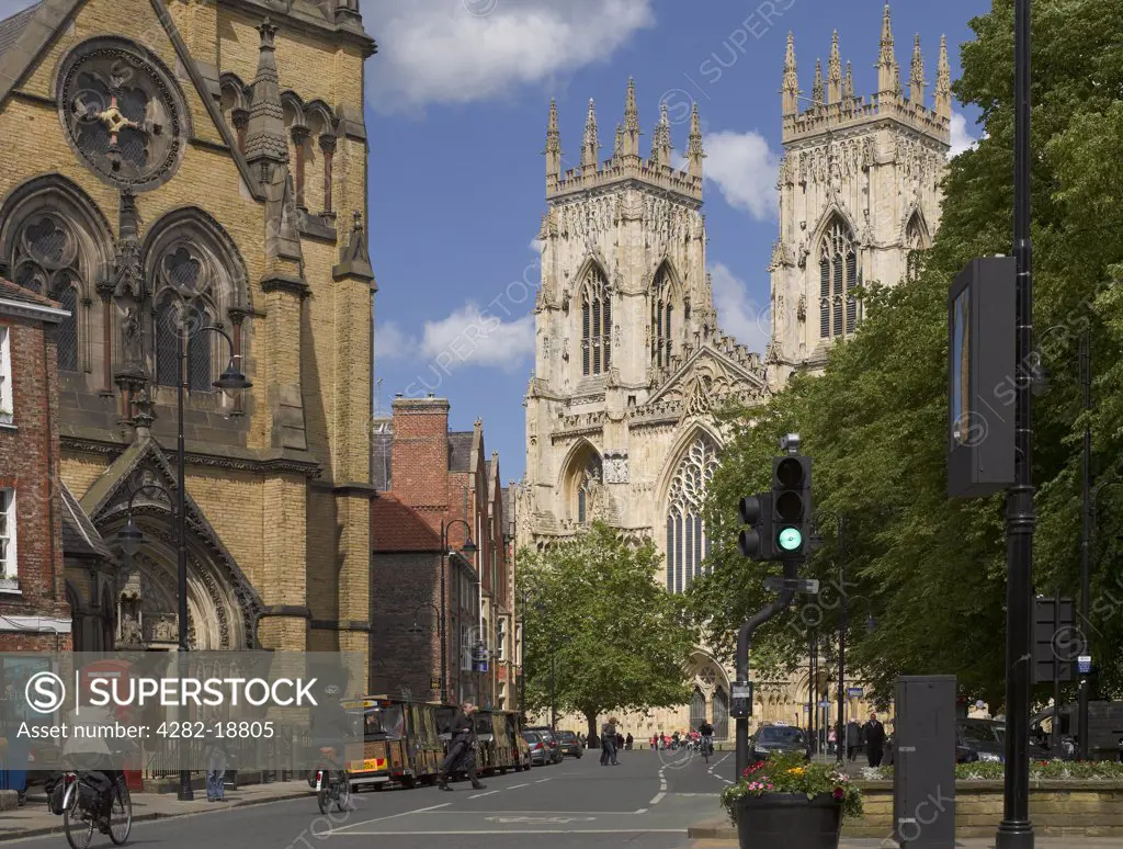 England, North Yorkshire, York. The West front of York Minster and St. Wilfrid's Catholic Church in Duncombe Place.