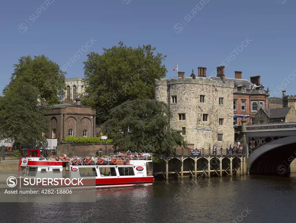 England, North Yorkshire, York. Tourists aboard a YorkBoat pleasure boat at Lendal Bridge Landing on the River Ouse.