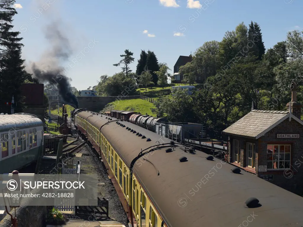 England, North Yorkshire, Goathland. A steam train leaving Goathland railway station on the North Yorkshire Moors Railway.