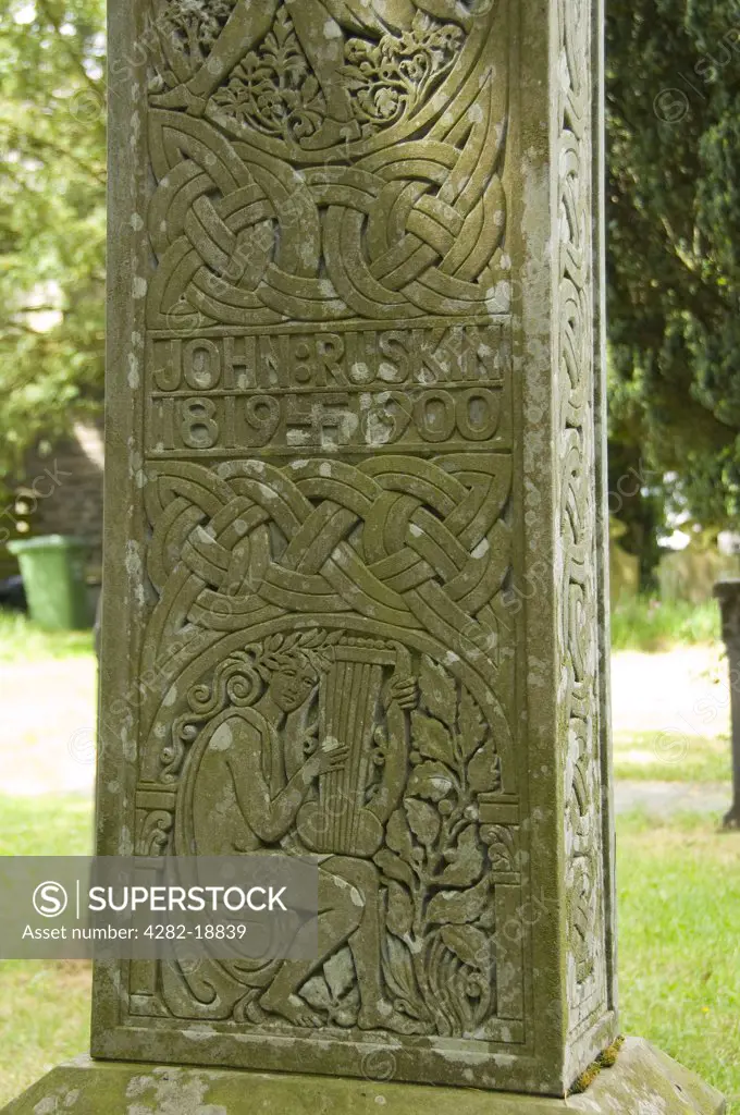 England, Cumbria, Coniston. Close up detail of a Celtic cross which marks the grave of John Ruskin, an author, poet and artist, in St Andrews churchyard in the village of Coniston.