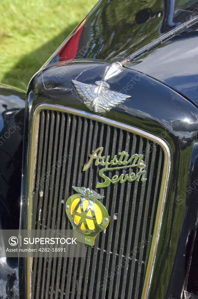 England, North Yorkshire, -. The front radiator grill of a black Austin Seven vintage car sporting an AA badge.