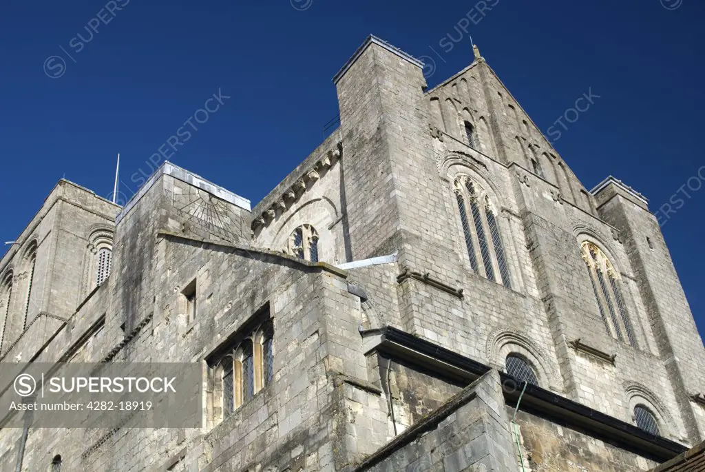 England, Hampshire, Winchester. Exterior view of Winchester Cathedral. Begun in 1079 in the Romanesque style, this Cathedral is at the heart of Alfred's Wessex and a diocese which once stretched from London's Thames to the Channel Islands.