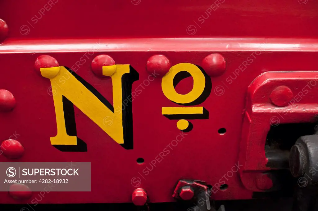 England, East Sussex, Horsted Keynes. A close up of painted text on a red steam engine at sheds in Horsted Keynes railway station in East Sussex.