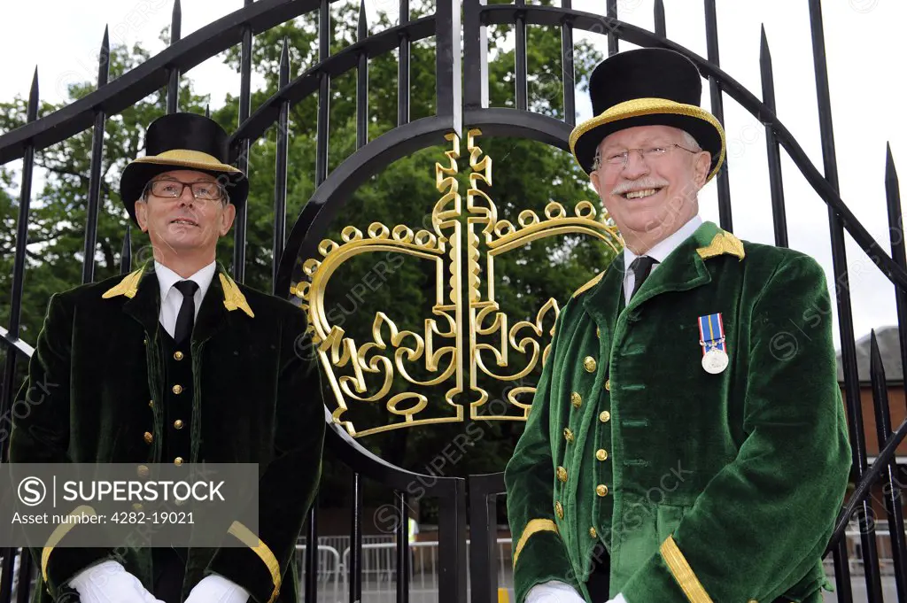 England, Berkshire, Ascot. Stewards wearing smart livery, manning the gate at Royal Ascot.