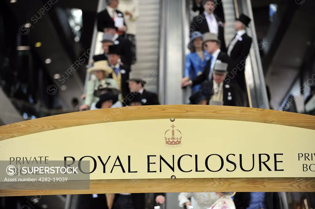 England, Berkshire, Ascot. Smartly dressed racegoers descending on escalators from private boxes in the Royal Enclosure during day one of Royal Ascot 2010.