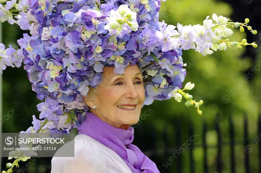 England, Berkshire, Ascot. A female racegoer wearing a large floral hat attending day one of Royal Ascot.