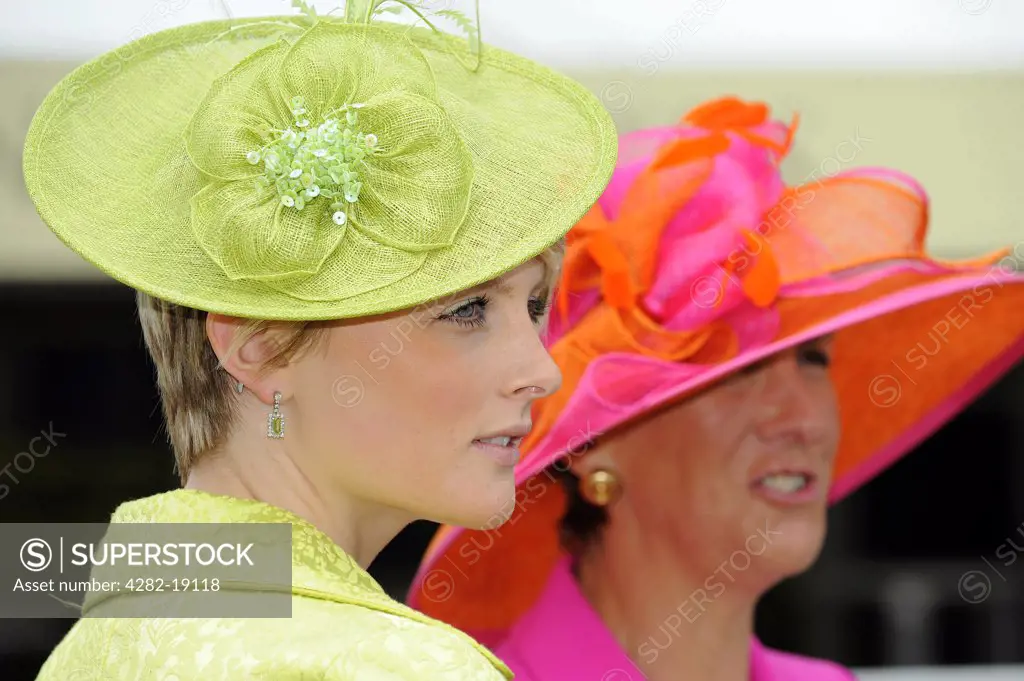 England, Berkshire, Ascot. Elegantly dressed women attending day one of Royal Ascot.