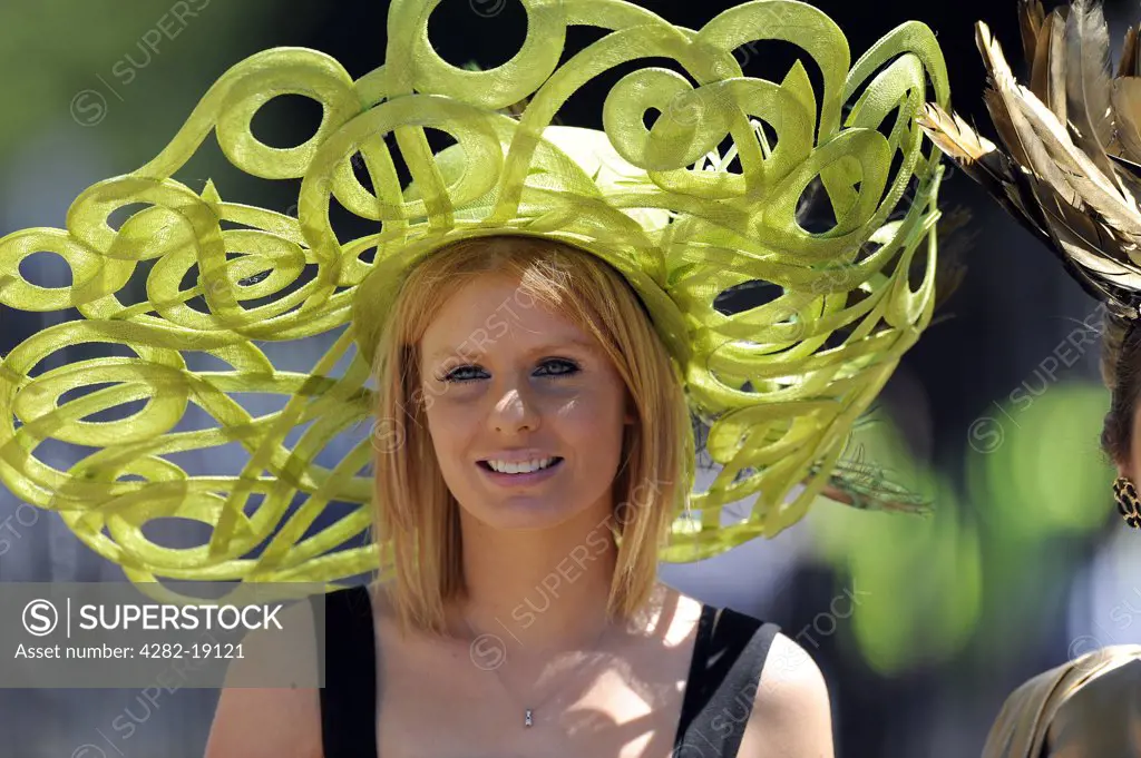 England, Berkshire, Ascot. A female racegoer wearing an elaborate hat attending day two of Royal Ascot 2010.