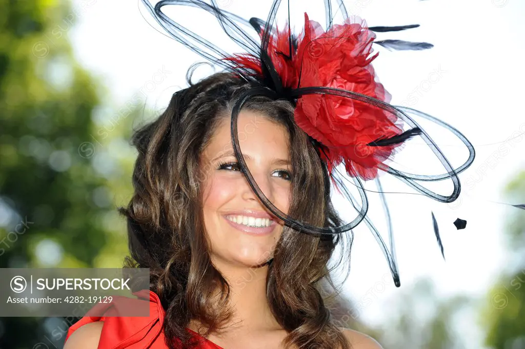 England, Berkshire, Ascot. A female racegoer wearing an elaborate hat attending day three of Royal Ascot 2010.
