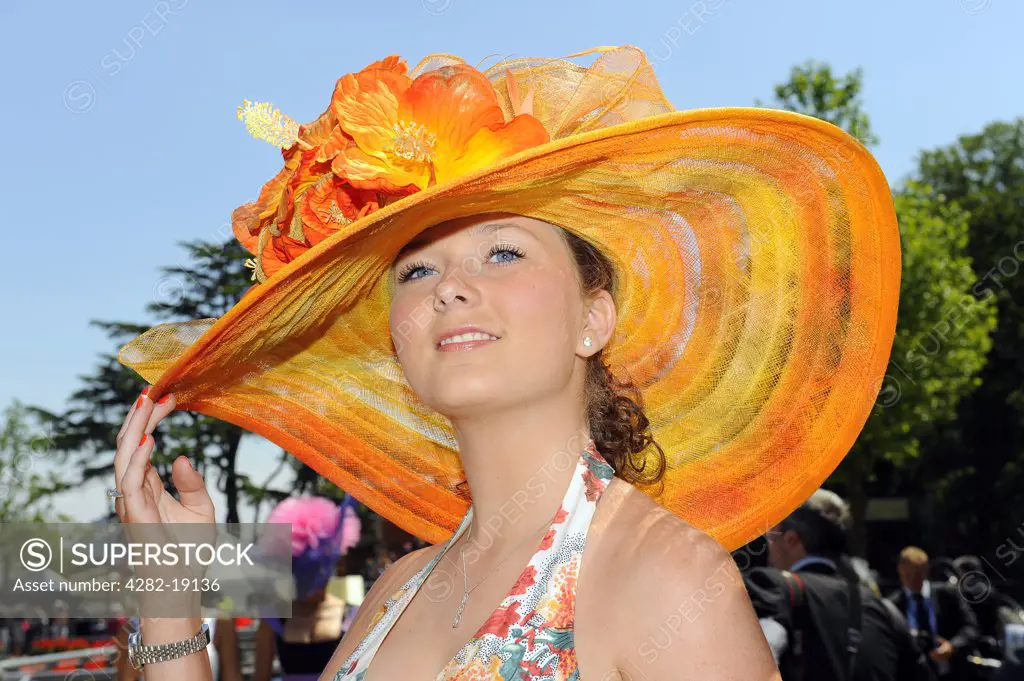 England, Berkshire, Ascot. A female racegoer wearing an elaborate hat attending day three of Royal Ascot 2010.