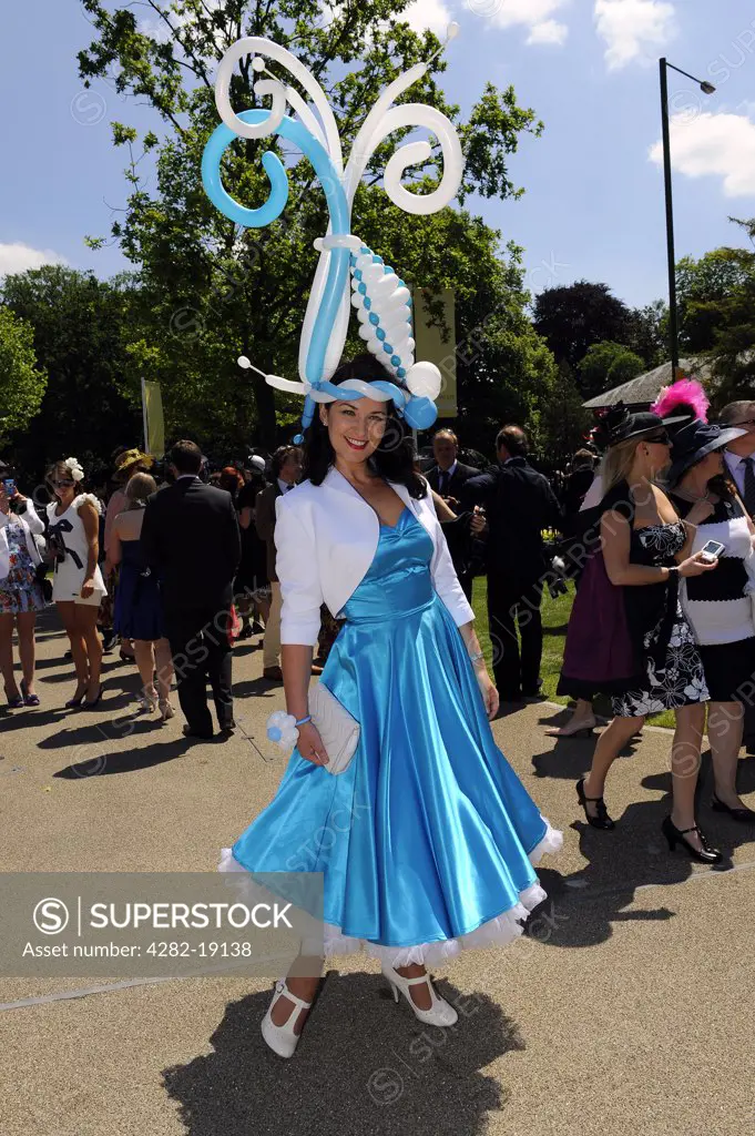 England, Berkshire, Ascot. A woman wearing an extravagant ballon hat attending day three of Royal Ascot 2010.