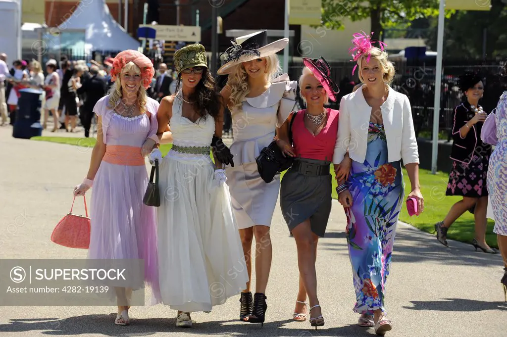England, Berkshire, Ascot. A group of smartly dressed women wearing elaborate hats attending day three of Royal Ascot 2010.