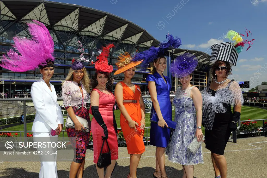 England, Berkshire, Ascot. A group of women wearing elaborate hats attending day three of Royal Ascot 2010.