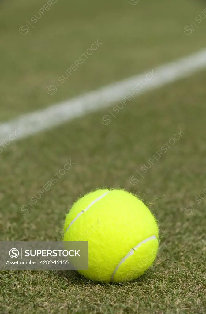 England, London, Wimbledon. Close-up of a tennis ball on a grass court at the Wimbledon Tennis Championships 2010.