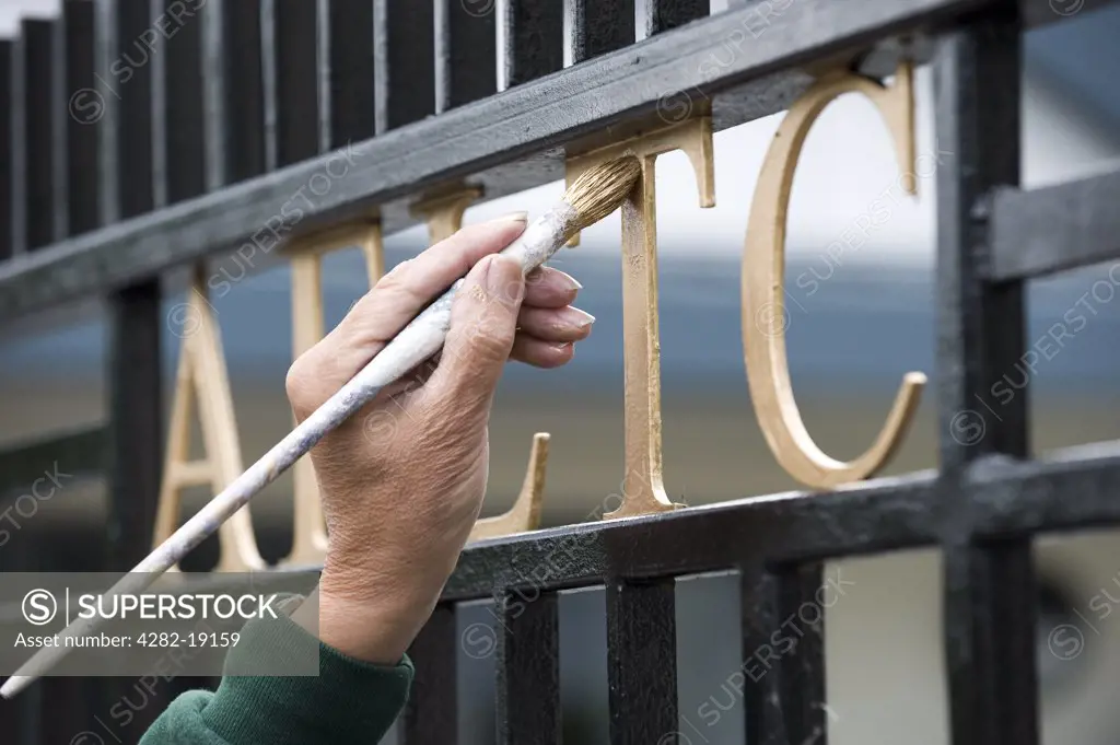 England, London, Wimbledon. The AELTC sign on a gate is painted before the Wimbledon Tennis Championships 2010.