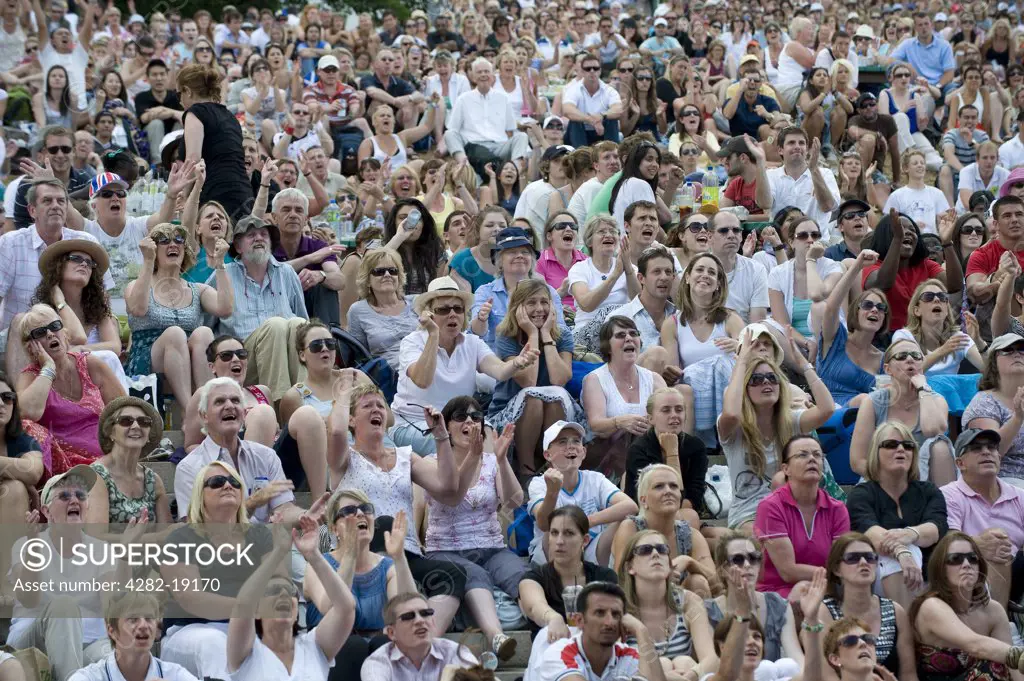 England, London, Wimbledon. Crowds watch play on the big screen on Henman Hill during the Wimbledon Tennis Championships 2010.