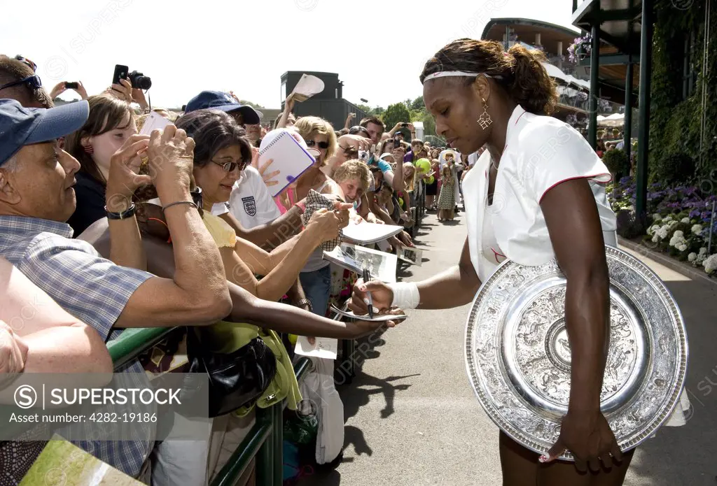England, London, Wimbledon. Serena Williams (USA) signing autographs outside Centre Court after victory in the 2010 Wimbledon Tennis Championships Ladies final.