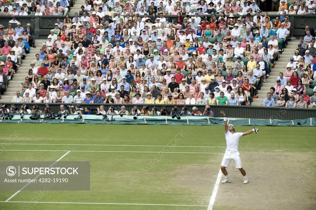England, London, Wimbledon. Rafael Nadal (ESP) serving during the mens singles final at the Wimbledon Tennis Championships 2010.