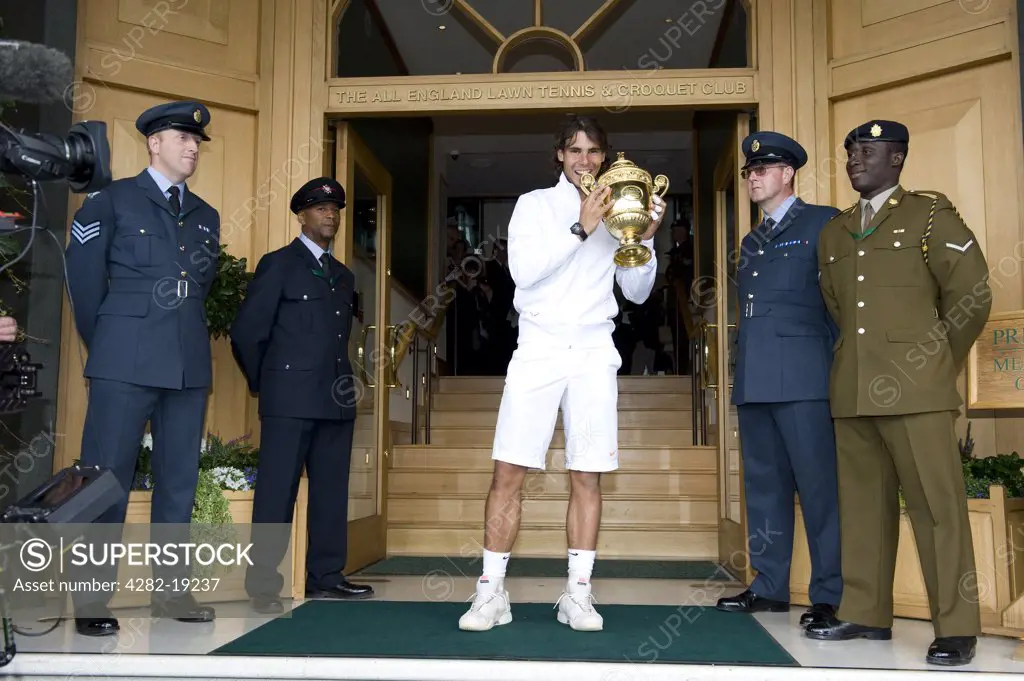 England, London, Wimbledon. Rafael Nadal (ESP) poses with the trophy outside the front steps of Centre Court after winning the men's Wimbledon Tennis Championships 2010.