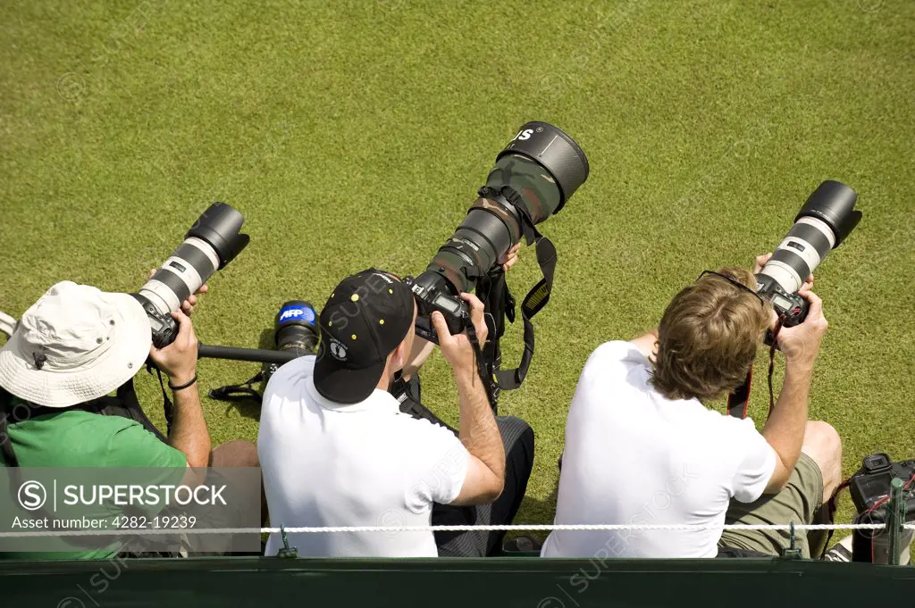 England, London, Wimbledon. Photographers capturing the action during the Wimbledon Tennis Championships 2010.