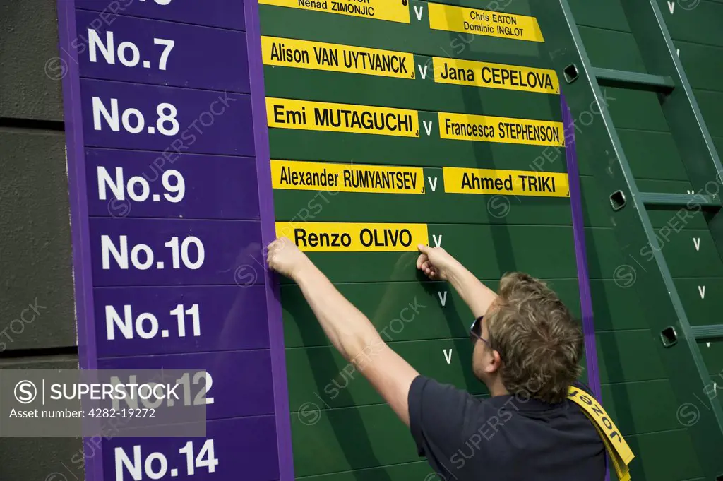England, London, Wimbledon. Players names being added to the order of play board for Saturday at the Wimbledon Tennis Championships 2010.