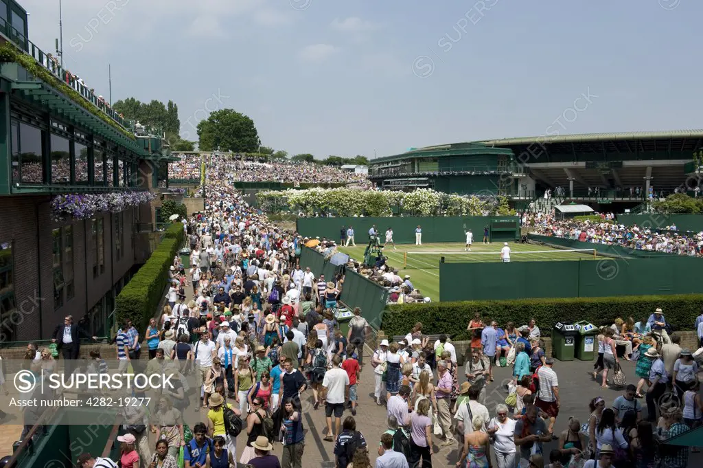 England, London, Wimbledon. Crowds on St Mary's Walk by Court 19 at the Wimbledon Tennis Championships 2010.