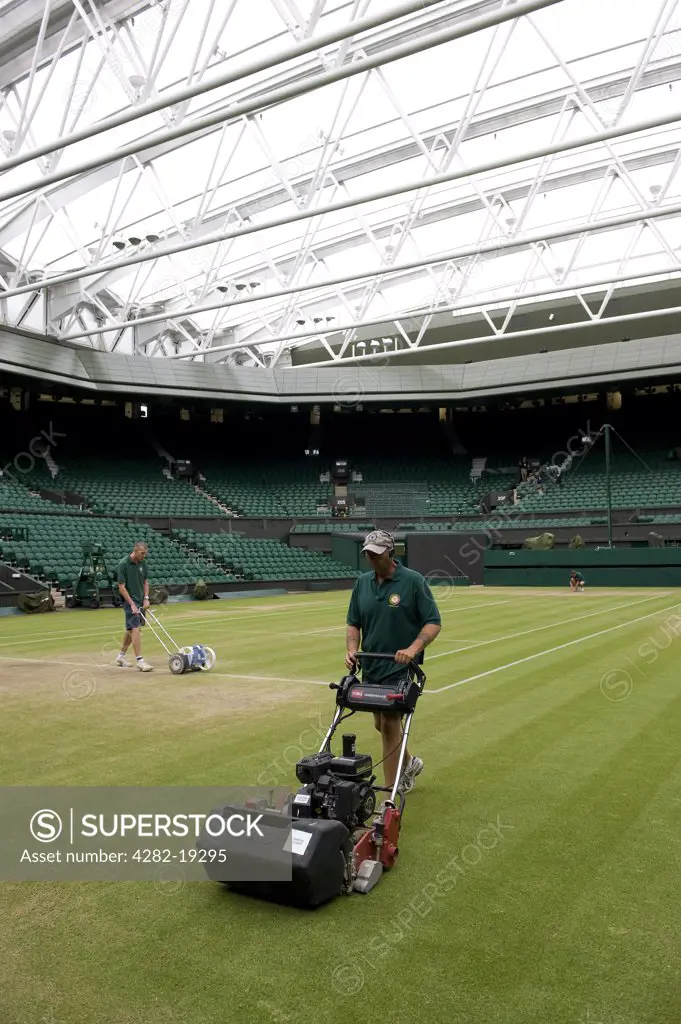 England, London, Wimbledon. Groundsmen preparing Centre Court under the retractable roof during the Wimbledon Tennis Championships 2010.