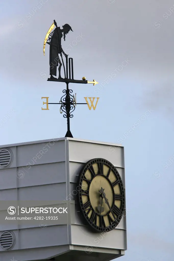 England, London, St Johns Wood. Old Father Time weather vain and clock at Lord's Cricket Ground.