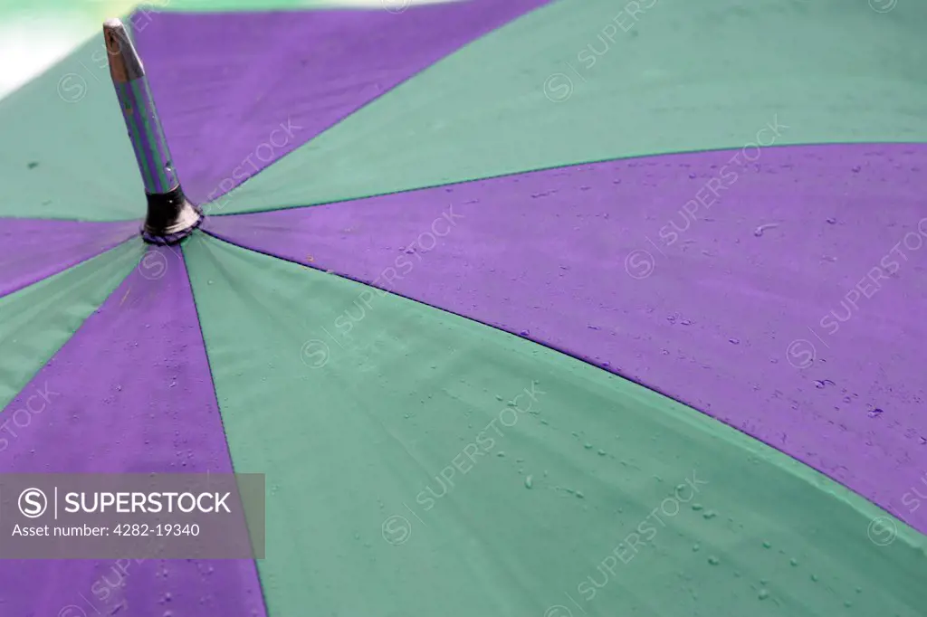 England, London, Wimbledon. Detail of raindrops on a Wimbledon umbrella at the Wimbledon Tennis Championships 2008.