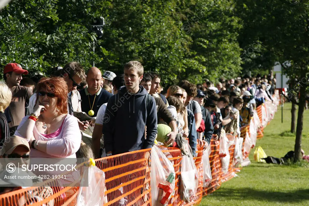 England, London, Wimbledon. Spectators queue outside the grounds to buy tickets for the first day of the championships at the Wimbledon Tennis Championships 2008.