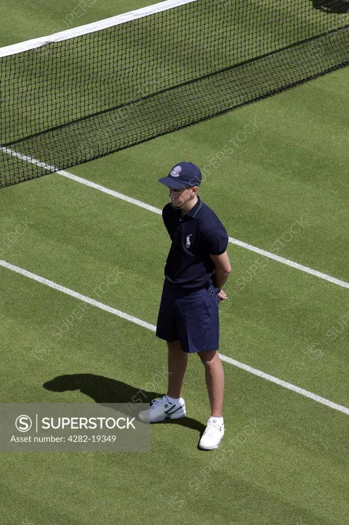 England, London, Wimbledon. A ball boy stands by the net during the Wimbledon Tennis Championships 2008.