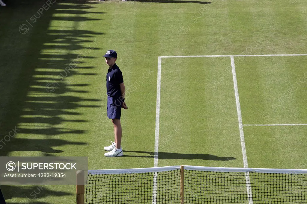England, London, Wimbledon. A ball boy stands during the change of ends during the Wimbledon Tennis Championships 2008.