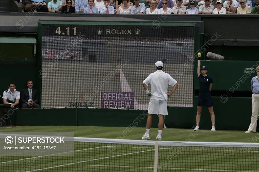 England, London, Wimbledon. A player watches the official review after a call is challenged during a match at the Wimbledon Tennis Championships 2008.