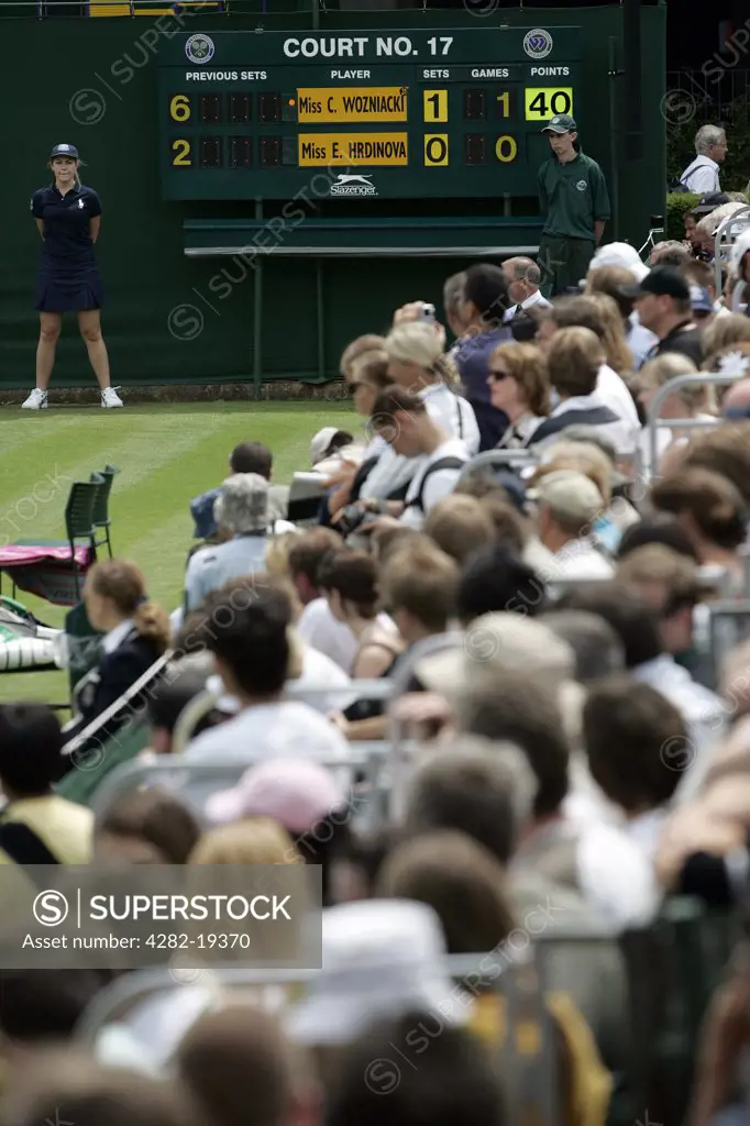 England, London, Wimbledon. Scoreboard and crowd on court 17 at the Wimbledon Tennis Championships 2008.