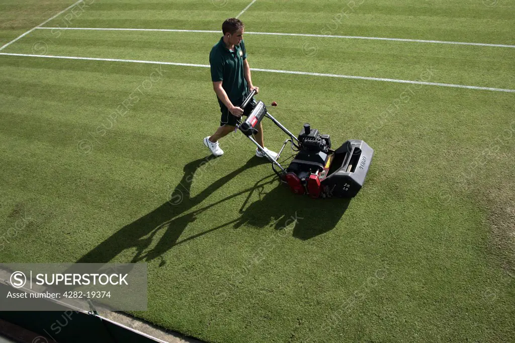 England, London, Wimbledon. The grass is cut on the outside courts during the Wimbledon Tennis Championships 2008.
