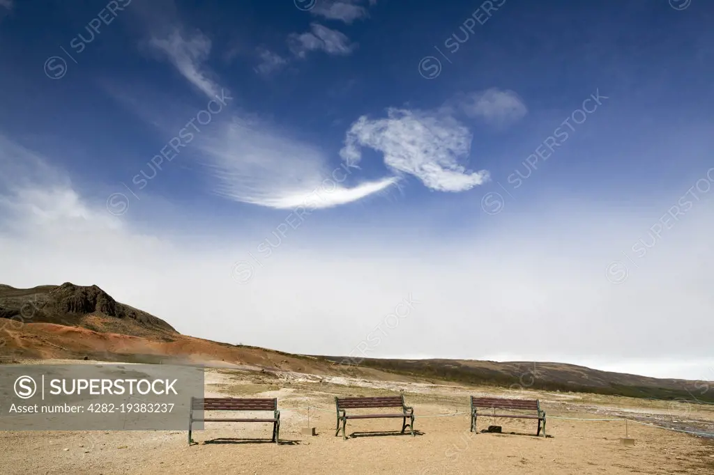 Benches in a line at Geysir in Iceland.