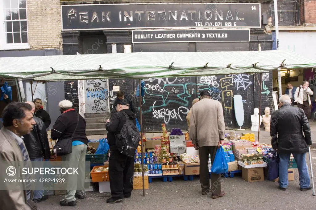 England, London, Brick Lane. Brick Lane Market. Almost anything can be found on Brick Lane, from antique books to eight-track cartridge decks (for many years it hosted a stall selling nothing but rusty cog wheels).