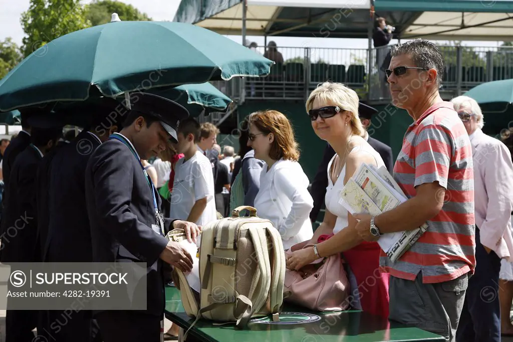 England, London, Wimbledon. Spectators have their bags searched at the entrance gates during the Wimbledon Tennis Championships 2008.