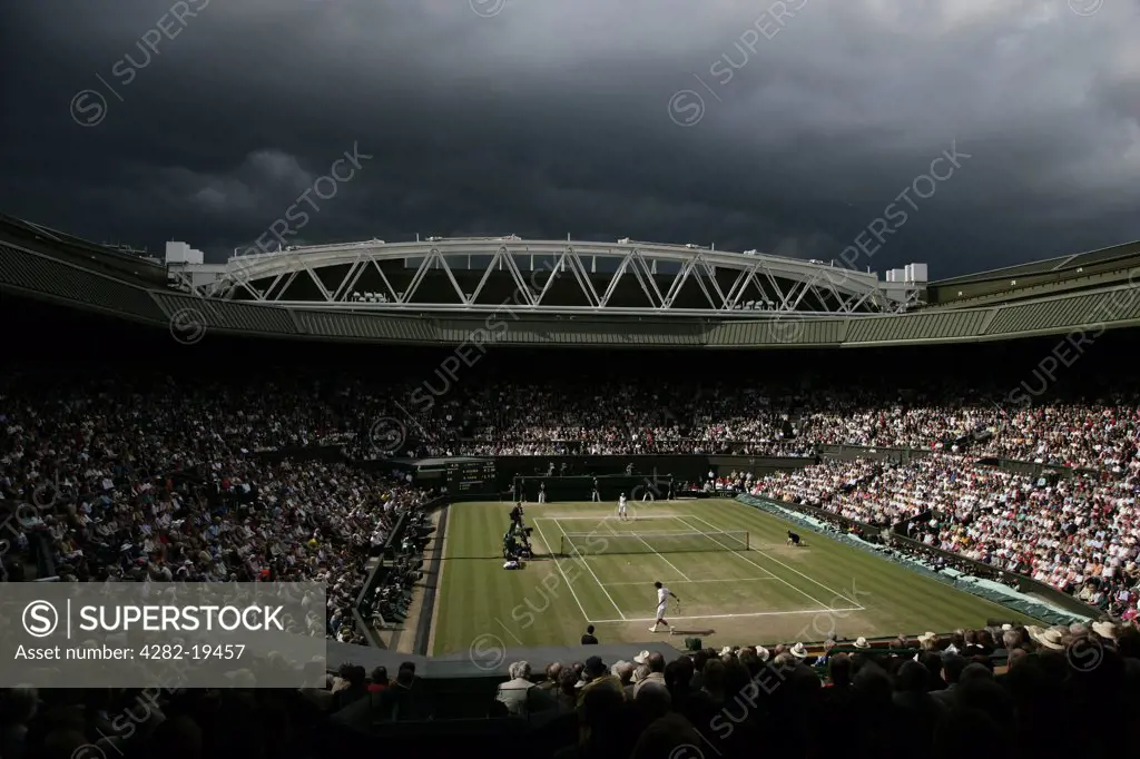 England, London, Wimbledon. View of centre court as dark clouds gather overhead during the Men's Singles Final played between Rafael Nadal and Roger Federer at the Wimbledon Tennis Championships 2008.