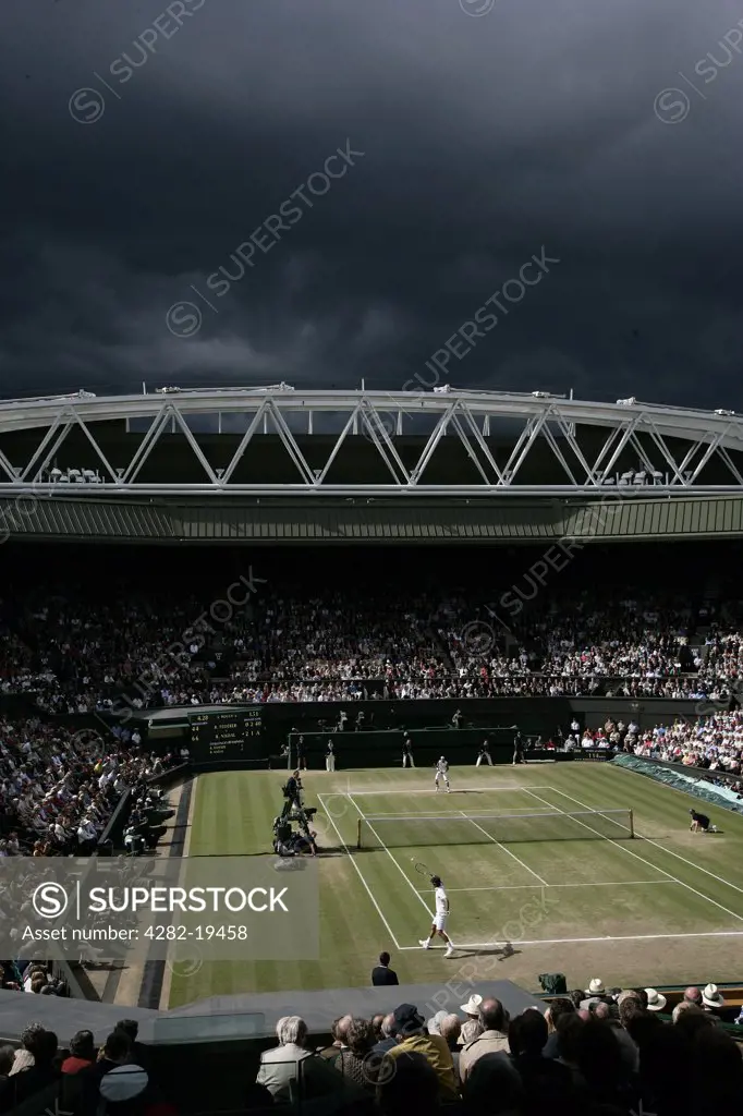 England, London, Wimbledon. View of centre court as dark clouds gather overhead during the Men's Singles Final played between Rafael Nadal and Roger Federer at the Wimbledon Tennis Championships 2008.