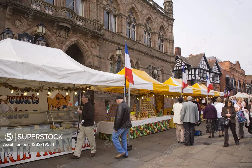 England, Cheshire, Chester. Outdoor French Market food stall counters by the Town Hall in Northgate Street.